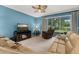 Comfortable living room featuring plush sofas, a ceiling fan, and sliding glass doors leading to an outdoor patio at 3606 Solana Cir, Clermont, FL 34711