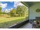 Cozy screened patio with wicker seating overlooking manicured lawns and lush landscaping at 3606 Solana Cir, Clermont, FL 34711