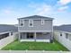 The backyard features lawn space, a fence, and a sliding glass door to the home at 3926 Palazzo Pl, Winter Haven, FL 33884