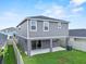 View of the home's backyard showing the lawn, fence, and sliding glass door at 3926 Palazzo Pl, Winter Haven, FL 33884