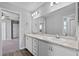 Bright bathroom featuring a double sink vanity with marble countertops and white cabinets at 3926 Palazzo Pl, Winter Haven, FL 33884