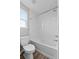 Clean white bathroom featuring a shower over tub with a white tiled surround at 3926 Palazzo Pl, Winter Haven, FL 33884