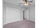 Bedroom featuring carpet, a ceiling fan and a double door closet at 3926 Palazzo Pl, Winter Haven, FL 33884