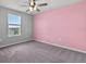 Bright bedroom with a ceiling fan and a large window for natural light at 3926 Palazzo Pl, Winter Haven, FL 33884