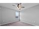 Neutral bedroom featuring carpet, a ceiling fan and a window for natural light at 3926 Palazzo Pl, Winter Haven, FL 33884