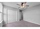 Neutral bedroom features carpet, a ceiling fan and a double door closet at 3926 Palazzo Pl, Winter Haven, FL 33884