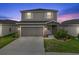 Charming two-story home showcasing the garage, walkway, and front door at 3926 Palazzo Pl, Winter Haven, FL 33884
