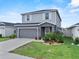 Charming home featuring a front lawn, garden bed, and two-car garage at 3926 Palazzo Pl, Winter Haven, FL 33884