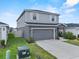 Two-story home showcasing well-maintained lawn, landscaping, and driveway at 3926 Palazzo Pl, Winter Haven, FL 33884