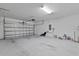 Large garage with an automatic door, overhead lighting, and painted concrete floors at 3926 Palazzo Pl, Winter Haven, FL 33884