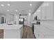 Bright and airy kitchen features white cabinets, stainless steel appliances, and quartz countertops at 3926 Palazzo Pl, Winter Haven, FL 33884
