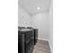 Laundry room featuring a black washer and dryer and wire shelving at 3926 Palazzo Pl, Winter Haven, FL 33884