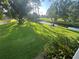 Scenic backyard view with a creek, lush green grass, and mature trees at 416 Howard Ave # D, Lakeland, FL 33815