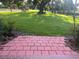 Backyard view from patio includes beautiful green grass and shade trees at 416 Howard Ave # D, Lakeland, FL 33815