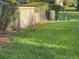 Grassy backyard features a chain-link fence, lush greenery, and a wild rabbit at 416 Howard Ave # D, Lakeland, FL 33815
