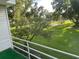 Balcony view overlooking the lush, green backyard and mature trees at 416 Howard Ave # D, Lakeland, FL 33815
