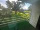 Balcony view showcasing lush green scenery, trees, and a creek under a sunny sky at 416 Howard Ave # D, Lakeland, FL 33815