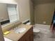 Bathroom with a single sink, toilet, and shower/tub combo with tile surround at 416 Howard Ave # D, Lakeland, FL 33815