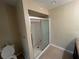 Clean bathroom with a white shower and toilet, neutral wall color and beige tile floor at 416 Howard Ave # D, Lakeland, FL 33815