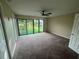 Expansive bedroom featuring plush carpeting, ceiling fan and a large sliding glass door to a rear deck at 416 Howard Ave # D, Lakeland, FL 33815