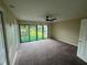 Spacious bedroom with neutral carpet, a ceiling fan, and a large sliding glass door to a rear deck at 416 Howard Ave # D, Lakeland, FL 33815