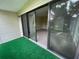 Bedroom balcony shows sliding glass doors, green turf and a lush, landscaped yard view at 416 Howard Ave # D, Lakeland, FL 33815
