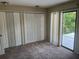 Bedroom with carpet, sliding glass doors to balcony and double closets at 416 Howard Ave # D, Lakeland, FL 33815