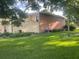 Spacious grassy area adjacent to the building, complemented by mature shade trees at 416 Howard Ave # D, Lakeland, FL 33815