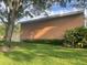 Brick exterior with a well-maintained lawn, surrounded by lush greenery and mature trees at 416 Howard Ave # D, Lakeland, FL 33815