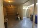 Spacious garage with shelving, large garage door, and side door to the exterior at 416 Howard Ave # D, Lakeland, FL 33815