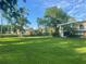 Expansive green lawn surrounded by mature trees and landscaping, creating a serene environment at 416 Howard Ave # D, Lakeland, FL 33815
