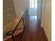 Hallway with hardwood floors, black railing, and white doors at 416 Howard Ave # D, Lakeland, FL 33815