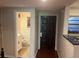 Hallway view features a decorative solid-wood door and half bathroom at 416 Howard Ave # D, Lakeland, FL 33815