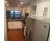 A well-lit kitchen featuring white cabinetry, stainless steel appliances, and wood flooring at 416 Howard Ave # D, Lakeland, FL 33815