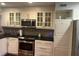 A well-lit kitchen featuring stainless steel appliances, granite countertops, and ample cabinet space at 416 Howard Ave # D, Lakeland, FL 33815