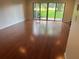 Spacious living room with a slider to the backyard and shiny wood floors at 416 Howard Ave # D, Lakeland, FL 33815