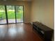 Bright living room boasts wood floors, slider to the outdoors, and a small table for electronics at 416 Howard Ave # D, Lakeland, FL 33815