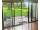 View of the patio and lawns from inside the home through sliding glass doors at 416 Howard Ave # D, Lakeland, FL 33815