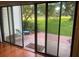 View through sliding glass doors to a brick patio and green lawns at 416 Howard Ave # D, Lakeland, FL 33815