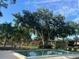 Enjoyable community pool area with mature trees and lounging area, for relaxation in a serene setting at 416 Howard Ave # D, Lakeland, FL 33815