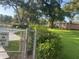 Well-maintained community pool area with seating, landscaping, and mature trees at 416 Howard Ave # D, Lakeland, FL 33815