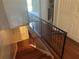 Wooden staircase with black railing leading to a hallway at 416 Howard Ave # D, Lakeland, FL 33815