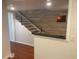 View of a stairway with wood steps, a black metal railing, and a decorative accent wall at 416 Howard Ave # D, Lakeland, FL 33815