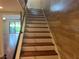 Stairway features brown wood steps, white risers, and opens to a living area with access to the backyard at 416 Howard Ave # D, Lakeland, FL 33815