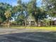Community tennis court surrounded by mature trees, creating a shaded and inviting recreational space at 416 Howard Ave # D, Lakeland, FL 33815