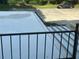 View from the balcony overlooking the parking lot and a dark vehicle at 416 Howard Ave # D, Lakeland, FL 33815