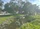 Scenic community water view with mature trees casting shadows, enhancing its serene setting at 416 Howard Ave # D, Lakeland, FL 33815