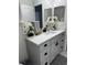 Bathroom vanity with neutral cabinet, quartz countertop, black hardware, and modern fixtures at 426 Cardinal Ct, Kissimmee, FL 34759