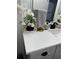 Bathroom vanity with neutral cabinet, quartz countertop, black hardware, and modern fixtures at 426 Cardinal Ct, Kissimmee, FL 34759