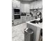 Modern kitchen featuring updated cabinets, stainless steel appliances, and a modern island with a black faucet at 426 Cardinal Ct, Kissimmee, FL 34759